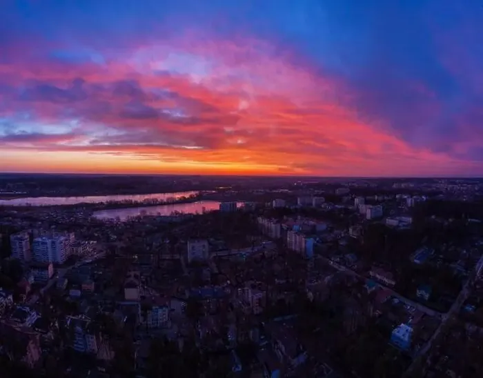 Framed Print : Aerial view of dramatic sunset sky with clouds above the city at dusk Framed Print : Aerial view of dramatic sunset sky with clouds above the city at dusk