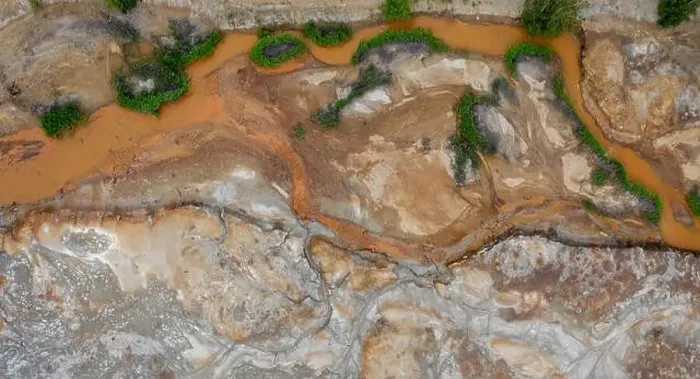 Framed Print : Aerial top down view; drone flying over a very polluted river with copper colored water; dumping of chemical waste into Framed Print : Aerial top down view; drone flying over a very polluted river with copper colored water; dumping of chemical waste into