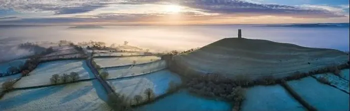 Framed Print : Aerial view by drone of frosty winter sunrise over Glastonbury Tor, Somerset, England, United Kingdom, Europe Framed Print : Aerial view by drone of frosty winter sunrise over Glastonbury Tor, Somerset, England, United Kingdom, Europe