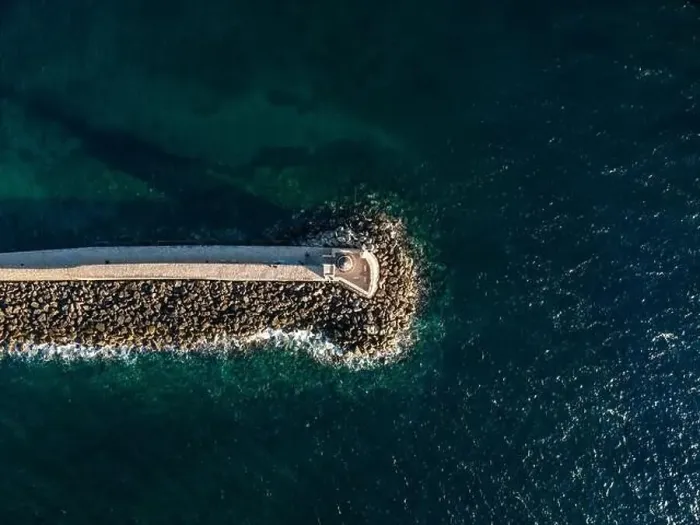 Framed Print : Aerial top view by drone of iconic Venetian lighthouse in the entrance of picturesque old port of Chania at sunset