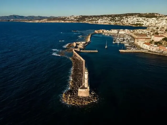 Framed Print : Aerial top view by drone of iconic Venetian lighthouse in the entrance of picturesque old port of Chania at sunset