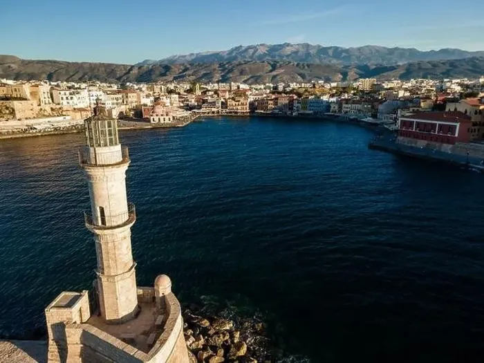 Framed Print : Aerial top view by drone of iconic Venetian lighthouse in the entrance of picturesque old port of Chania at sunset