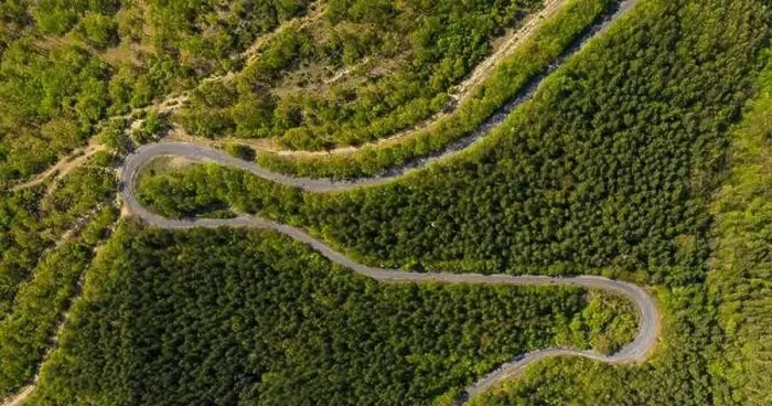 Framed Print : Aerial view from drone to the road through mountain Framed Print : Aerial view from drone to the road through mountain