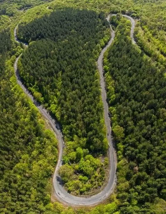 Framed Print : Aerial view from drone to the road through mountain Framed Print : Aerial view from drone to the road through mountain