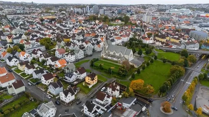 Framed Print : Aerial view of a European city with a prominent church surrounded by residential houses and greenery