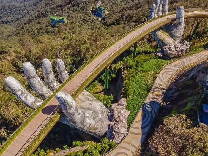 Framed Print : Top aerial view of the famous Golden Bridge is lifted by two giant hands in the tourist resort on Ba Na Hill in Da Nang Framed Print : Top aerial view of the famous Golden Bridge is lifted by two giant hands in the tourist resort on Ba Na Hill in Da Nang