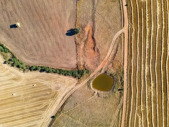 Framed Print : Aerial view of farm fields, dirt roads and water basin Framed Print : Aerial view of farm fields, dirt roads and water basin