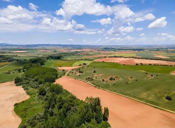 Framed Print : Aerial view of fields of Castile with agricultural plots and blue sky with clouds. Castilla