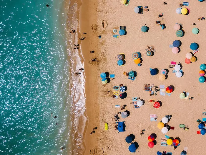 Framed Print : Aerial View From Flying Drone Of People Crowd Relaxing On Algarve Beach In Portugal Framed Print : Aerial View From Flying Drone Of People Crowd Relaxing On Algarve Beach In Portugal