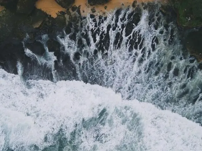 Framed Print : Top down aerial view of giant ocean waves crashing and foaming in coral beach Framed Print : Top down aerial view of giant ocean waves crashing and foaming in coral beach