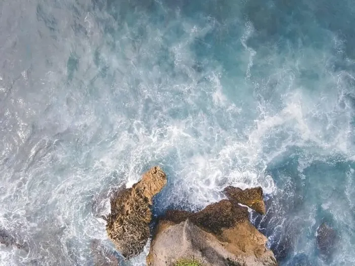 Framed Print : Top down aerial view of giant ocean waves crashing and foaming in coral beach Framed Print : Top down aerial view of giant ocean waves crashing and foaming in coral beach