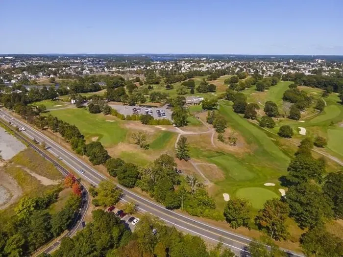 Framed Print : Aerial view of a golf course and Veterans Memorial Pkwy with historic city at the background in East Providence Framed Print : Aerial view of a golf course and Veterans Memorial Pkwy with historic city at the background in East Providence
