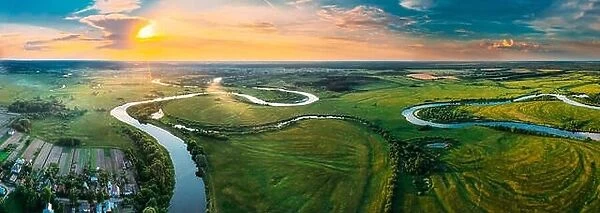 Aerial View Green Forest Woods Meadow And River Landscape In Sunny Spring Evening. Top View Of Beautiful European Nature From High Attitude In Summer