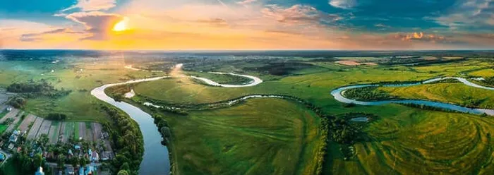 Framed Print : Aerial View Green Forest Woods Meadow And River Landscape In Sunny Spring Evening. Top View Of Beautiful European Nature From High Attitude In Summer Framed Print : Aerial View Green Forest Woods Meadow And River Landscape In Sunny Spring Evening. Top View Of Beautiful European Nature From High Attitude In Summer