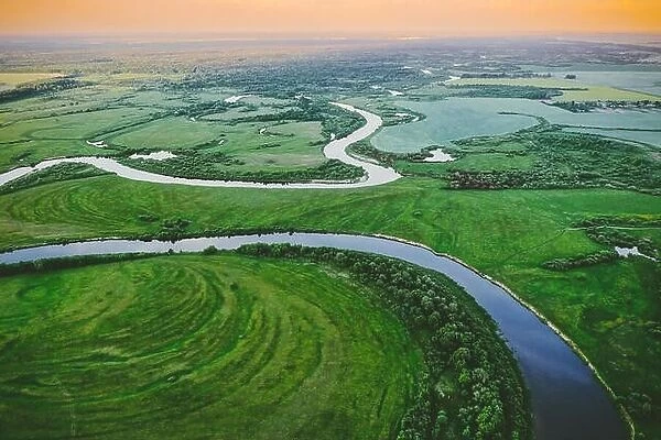 Aerial View Green Meadow And River Landscape In Sunny Spring Evening. Top View Of Beautiful European Nature From High Attitude In Summer Season. Drone
