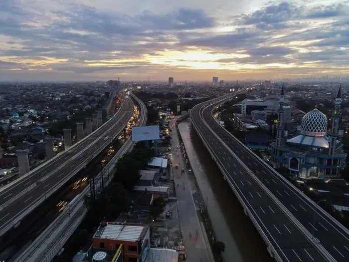 Framed Print : Aerial view of highway intersection and buildings in the city of Bekasi and noise cloud with Bekasi cityscape