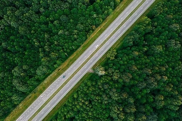Aerial View Of Highway Road Through Green Forest Landscape In Summer. Top View Flat View Of Highway Motorway Freeway From High Attitude. Trip And Trav
