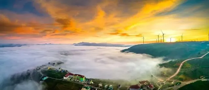 Framed Print : Aerial view top hill at dawn with fog covering small village in valley
