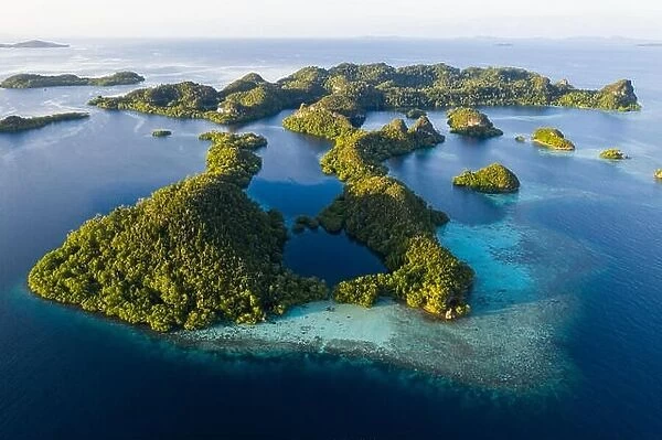 An aerial view of islands in Raja Ampat. This area is the heart of marine biodiversity and is a popular destination for scuba divers and snorkelers