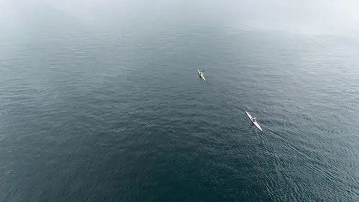 Framed Print : Aerial view of two kayakers paddling on a calm, expansive fjord Framed Print : Aerial view of two kayakers paddling on a calm, expansive fjord