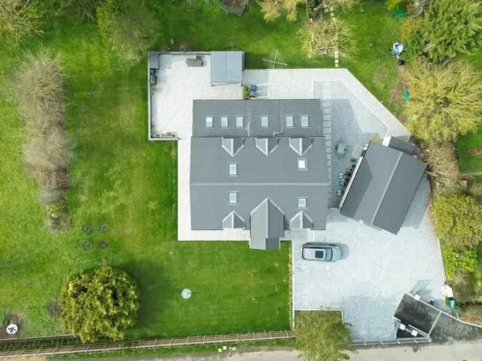 Framed Print : Aerial view of a large, recently built house which was built onto a previous bungalow