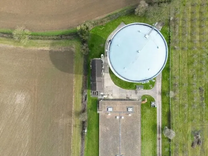 Framed Print : Aerial, top down view of a large water tower seen at the edge of a large shed which houses chickens Framed Print : Aerial, top down view of a large water tower seen at the edge of a large shed which houses chickens