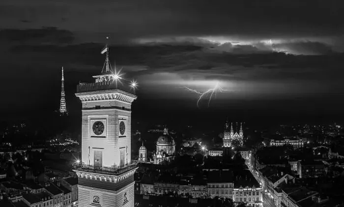 Framed Print : Aerial view on Lviv city hall at night from drone with lightning on the sky Framed Print : Aerial view on Lviv city hall at night from drone with lightning on the sky