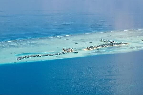 Aerial view on Maldives island. Luxury water and beach villas, bungalows with amazing nature seascape landscape. Luxury travel and vacation