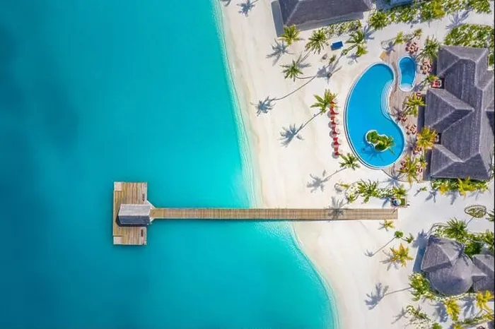 Framed Print : Aerial view of Maldives island, luxury water villas resort and wooden pier. Beautiful sky and ocean lagoon beach background. Summer vacation holiday Framed Print : Aerial view of Maldives island, luxury water villas resort and wooden pier. Beautiful sky and ocean lagoon beach background. Summer vacation holiday