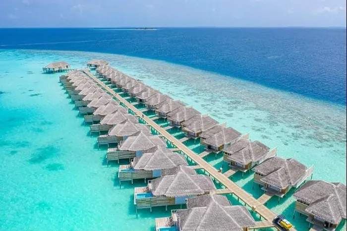 Framed Print : Aerial view of Maldives island, luxury water villas resort and wooden pier. Beautiful sky and ocean lagoon beach background. Summer vacation holiday Framed Print : Aerial view of Maldives island, luxury water villas resort and wooden pier. Beautiful sky and ocean lagoon beach background. Summer vacation holiday