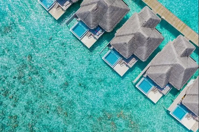 Framed Print : Aerial view of Maldives island, luxury water villas resort and wooden pier. Beautiful sky and ocean lagoon beach background. Summer vacation holiday Framed Print : Aerial view of Maldives island, luxury water villas resort and wooden pier. Beautiful sky and ocean lagoon beach background. Summer vacation holiday