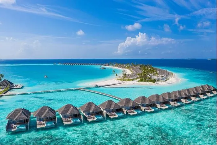 Framed Print : Aerial view of Maldives island, luxury water villas resort and wooden pier. Beautiful sky and ocean lagoon beach background. Summer vacation holiday Framed Print : Aerial view of Maldives island, luxury water villas resort and wooden pier. Beautiful sky and ocean lagoon beach background. Summer vacation holiday