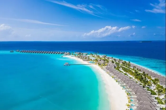 Framed Print : Aerial view of Maldives island, luxury water villas resort and wooden pier. Beautiful sky and ocean lagoon beach background. Summer vacation holiday Framed Print : Aerial view of Maldives island, luxury water villas resort and wooden pier. Beautiful sky and ocean lagoon beach background. Summer vacation holiday