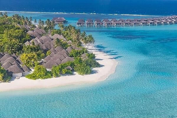 Aerial view on Maldives islands. Summer exotic landscape and seascape as aerial tropical background. Amazing view from above, luxury water bungalows