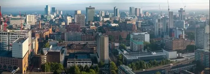 Framed Print : Aerial view of Manchester cityscape with skyscrapers and construction sites Framed Print : Aerial view of Manchester cityscape with skyscrapers and construction sites