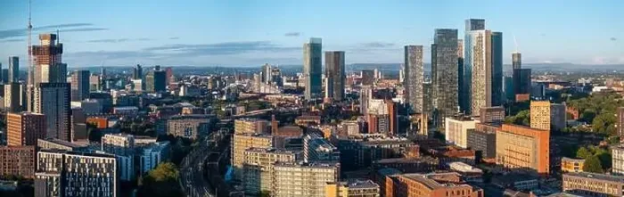 Framed Print : Aerial view of Manchester cityscape with skyscrapers and construction sites Framed Print : Aerial view of Manchester cityscape with skyscrapers and construction sites
