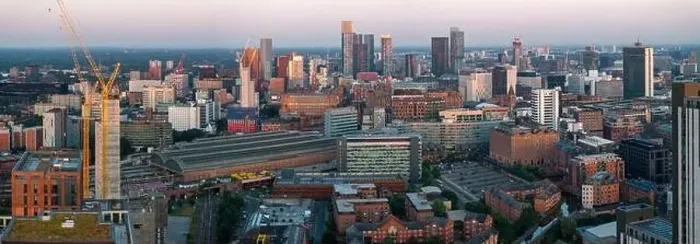 Framed Print : Aerial view of Manchester cityscape with skyscrapers and construction sites Framed Print : Aerial view of Manchester cityscape with skyscrapers and construction sites