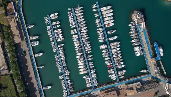 Framed Print : Aerial view of a marina with rows of boats docked in the calm turquoise water Framed Print : Aerial view of a marina with rows of boats docked in the calm turquoise water