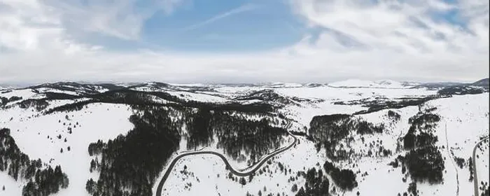 Framed Print : Aerial view of mountain landscape with road and lake in beautiful winter environment Framed Print : Aerial view of mountain landscape with road and lake in beautiful winter environment