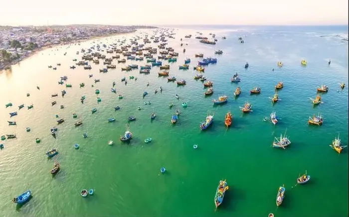 Framed Print : Aerial view of Mui Ne fishing village in the morning with hundreds of boats anchored to avoid storms Framed Print : Aerial view of Mui Ne fishing village in the morning with hundreds of boats anchored to avoid storms