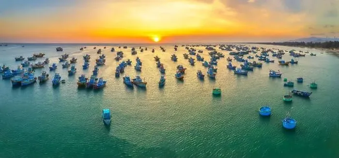 Framed Print : Aerial view of Mui Ne fishing village in sunset sky with hundreds of boats anchored to avoid storms Framed Print : Aerial view of Mui Ne fishing village in sunset sky with hundreds of boats anchored to avoid storms