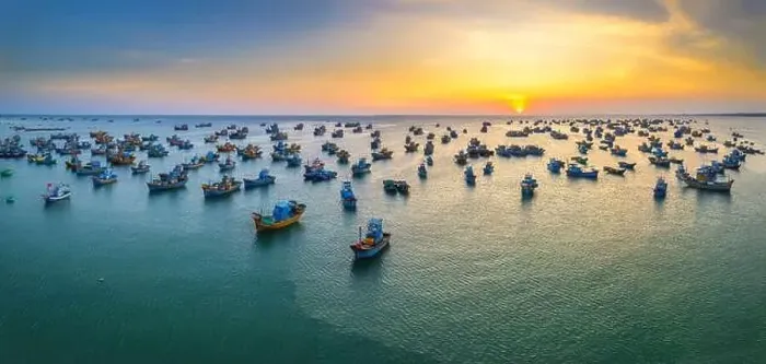 Framed Print : Aerial view of Mui Ne fishing village in sunset sky with hundreds of boats anchored to avoid storms