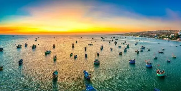 Framed Print : Aerial view of Mui Ne fishing village in sunset sky with hundreds of boats anchored to avoid storms