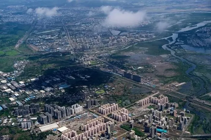 Framed Print : An aerial view of Mumbai's skyline passing over a building with roads and bridges Framed Print : An aerial view of Mumbai's skyline passing over a building with roads and bridges