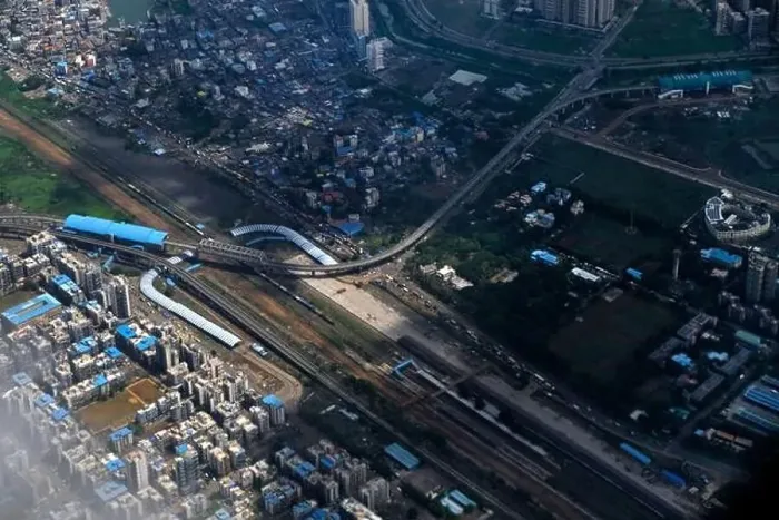 Framed Print : An aerial view of Mumbai's skyline passing over a building with roads and bridges Framed Print : An aerial view of Mumbai's skyline passing over a building with roads and bridges