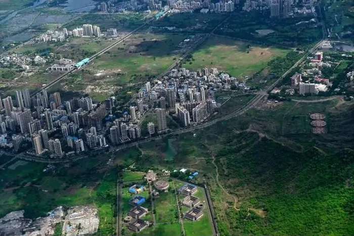 Framed Print : An aerial view of Mumbai's skyline passing over a building with roads and bridges Framed Print : An aerial view of Mumbai's skyline passing over a building with roads and bridges