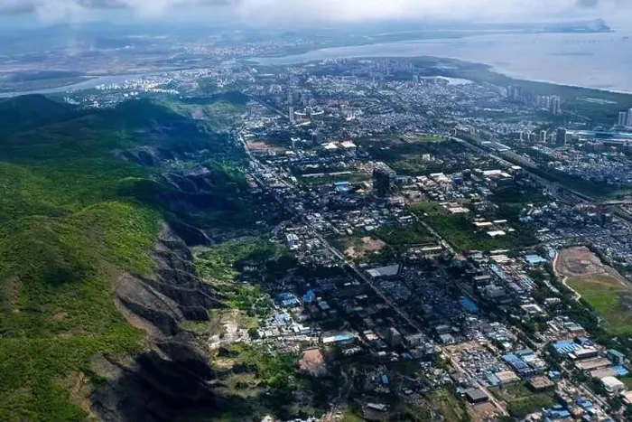 Framed Print : An aerial view of Mumbai's skyline passing over a building with roads and bridges