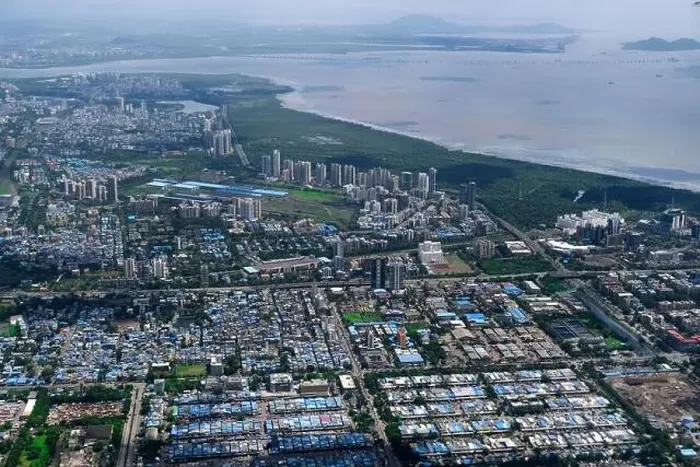 Framed Print : An aerial view of Mumbai's skyline passing over a building with roads and bridges Framed Print : An aerial view of Mumbai's skyline passing over a building with roads and bridges