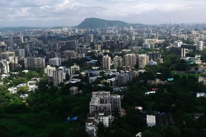 Framed Print : An aerial view of Mumbai's skyline passing over a building with roads and bridges Framed Print : An aerial view of Mumbai's skyline passing over a building with roads and bridges