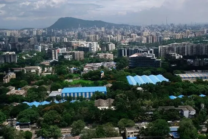 Framed Print : An aerial view of Mumbai's skyline passing over a building with roads and bridges
